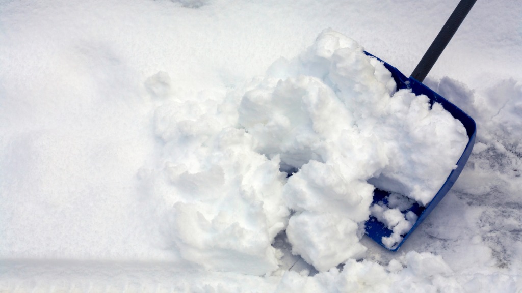 Shoveling snow with a blue shovel picture id174967676